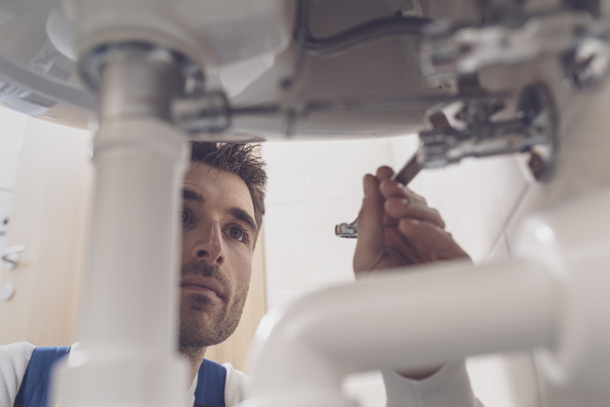 Plumber fixing a sink at home